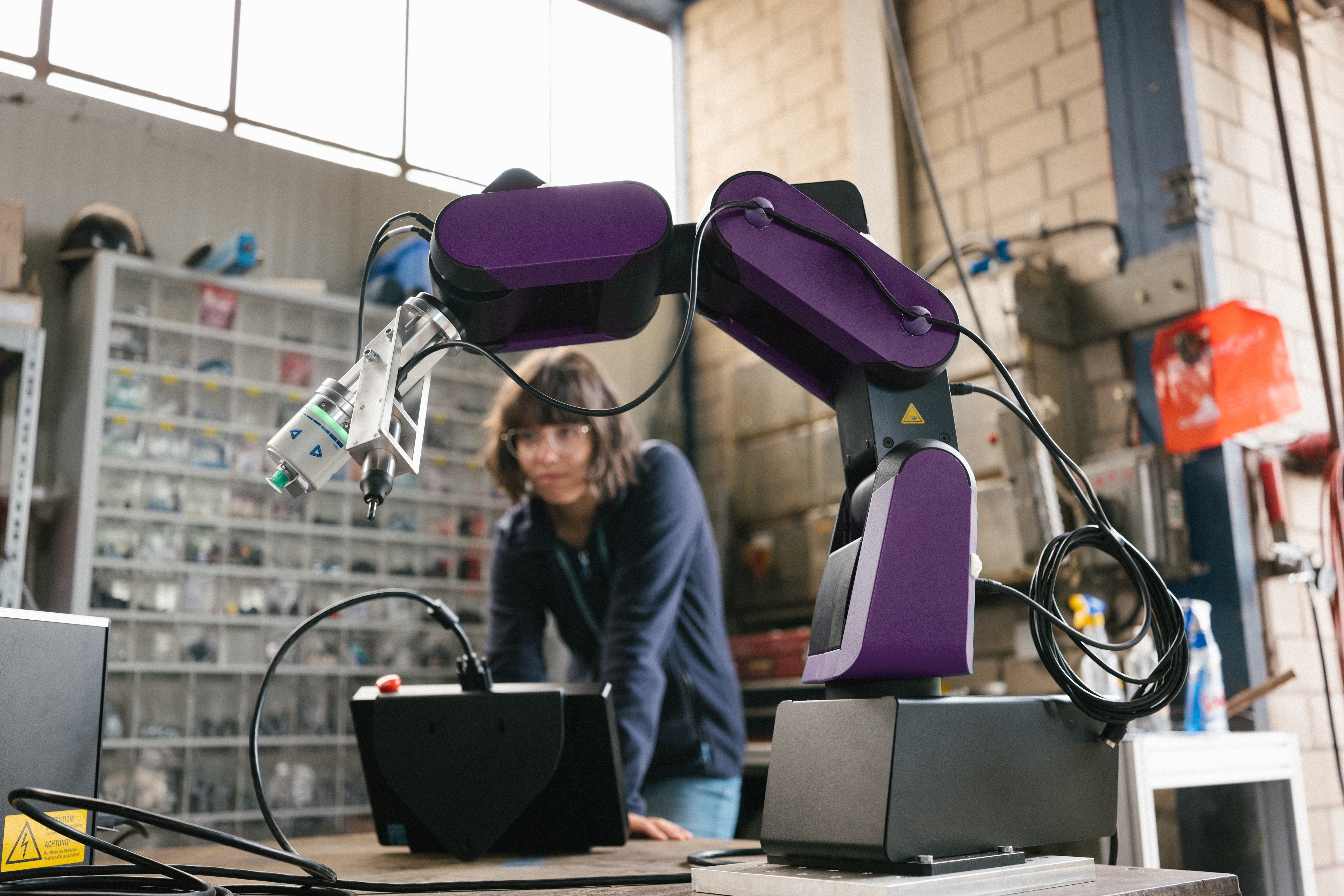 Woman-working-with-robotic-arm.jpg